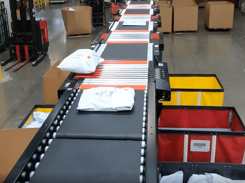 a photo of an eSort in action sorting parcels into designated bins.